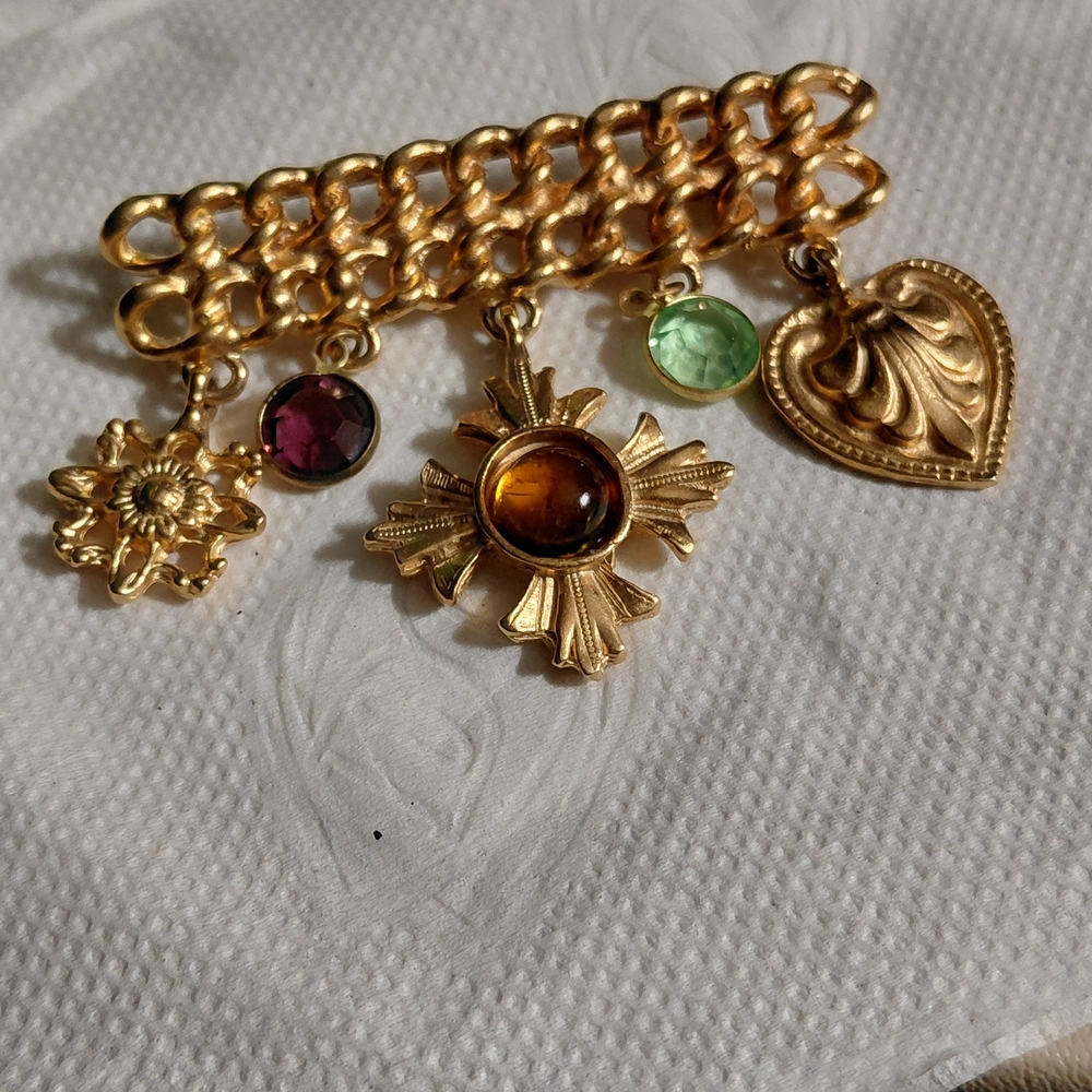 Gold-Tone Multi-Charm Brooch with Amber Center and Purple & Green Accents